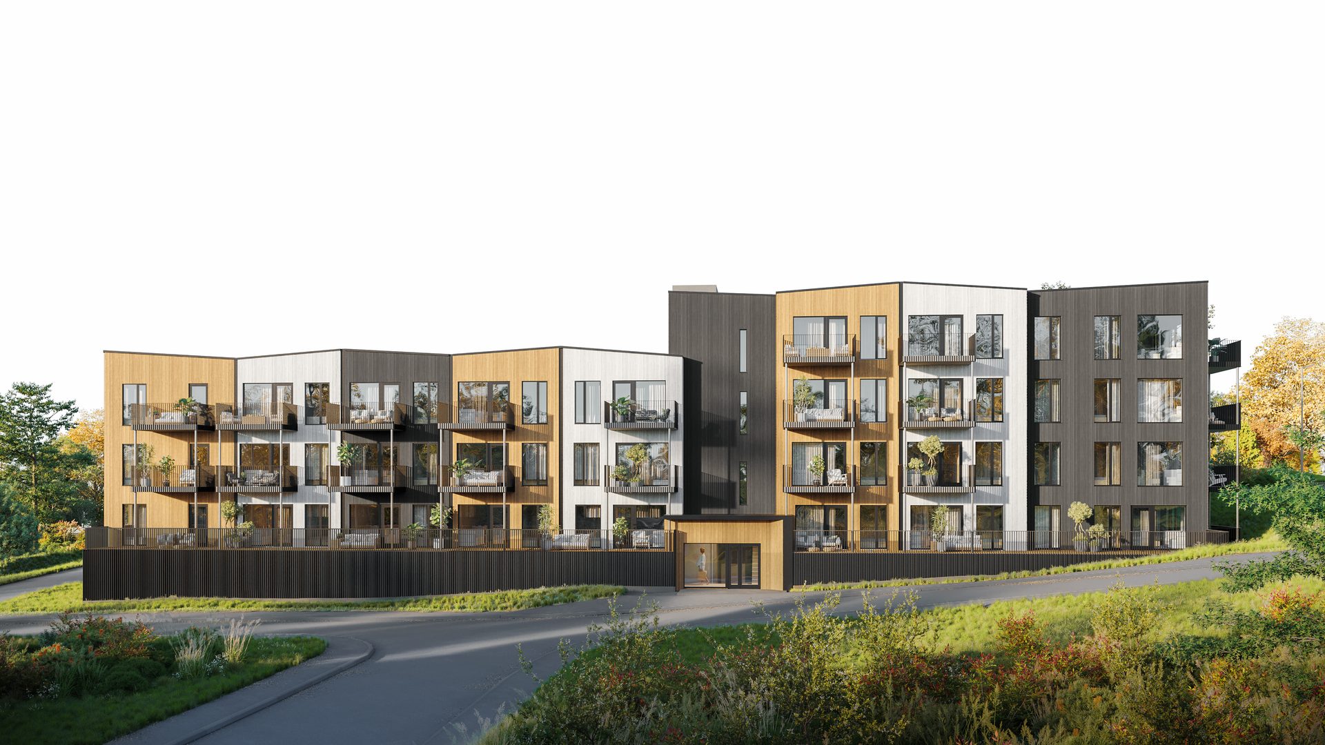 Gimletun, leilighetsbygg i tre og grønne fasader ved kveldslys, med sykkelvei og beplantning foran.